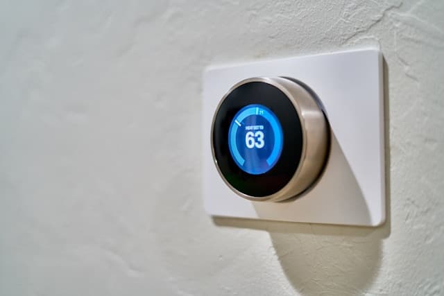 Nest smart thermostat installed on a wall